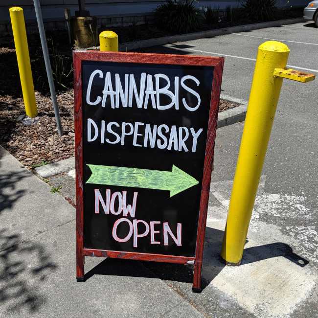 Sign reading cannabis dispensary now open