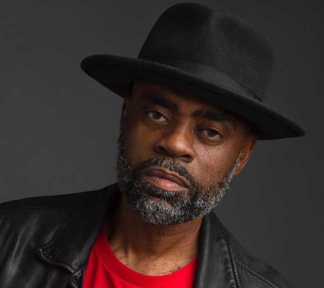 Image of Freeway Rick ross wearing a brimmed hat.