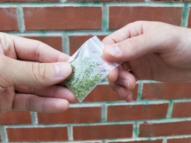 Someone dealing black market weed to another person