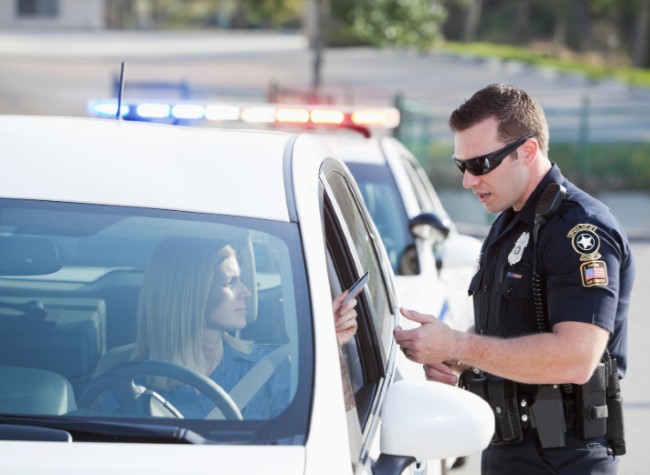 A woman getting pulled over by a police