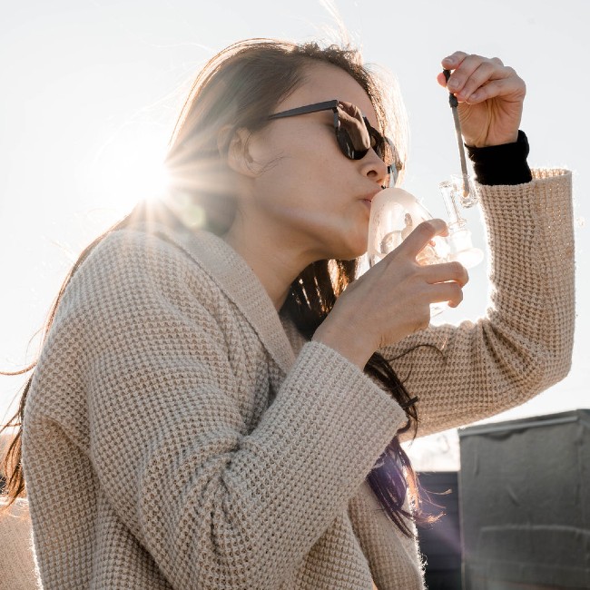 A woman taking a dab