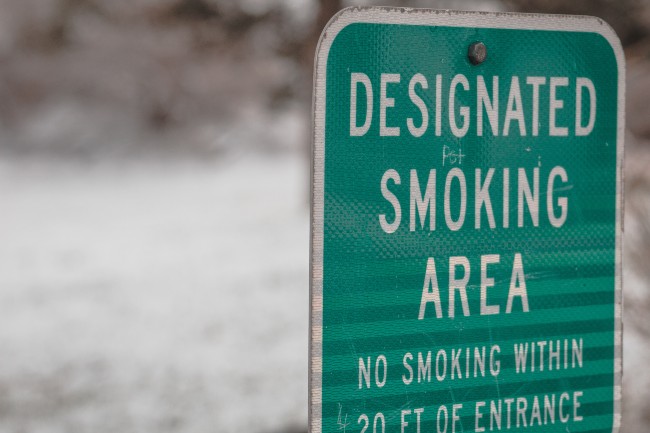 A sign that says Designated smoking area