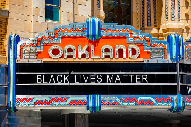 A sign that says Oakland and then black lives matter
