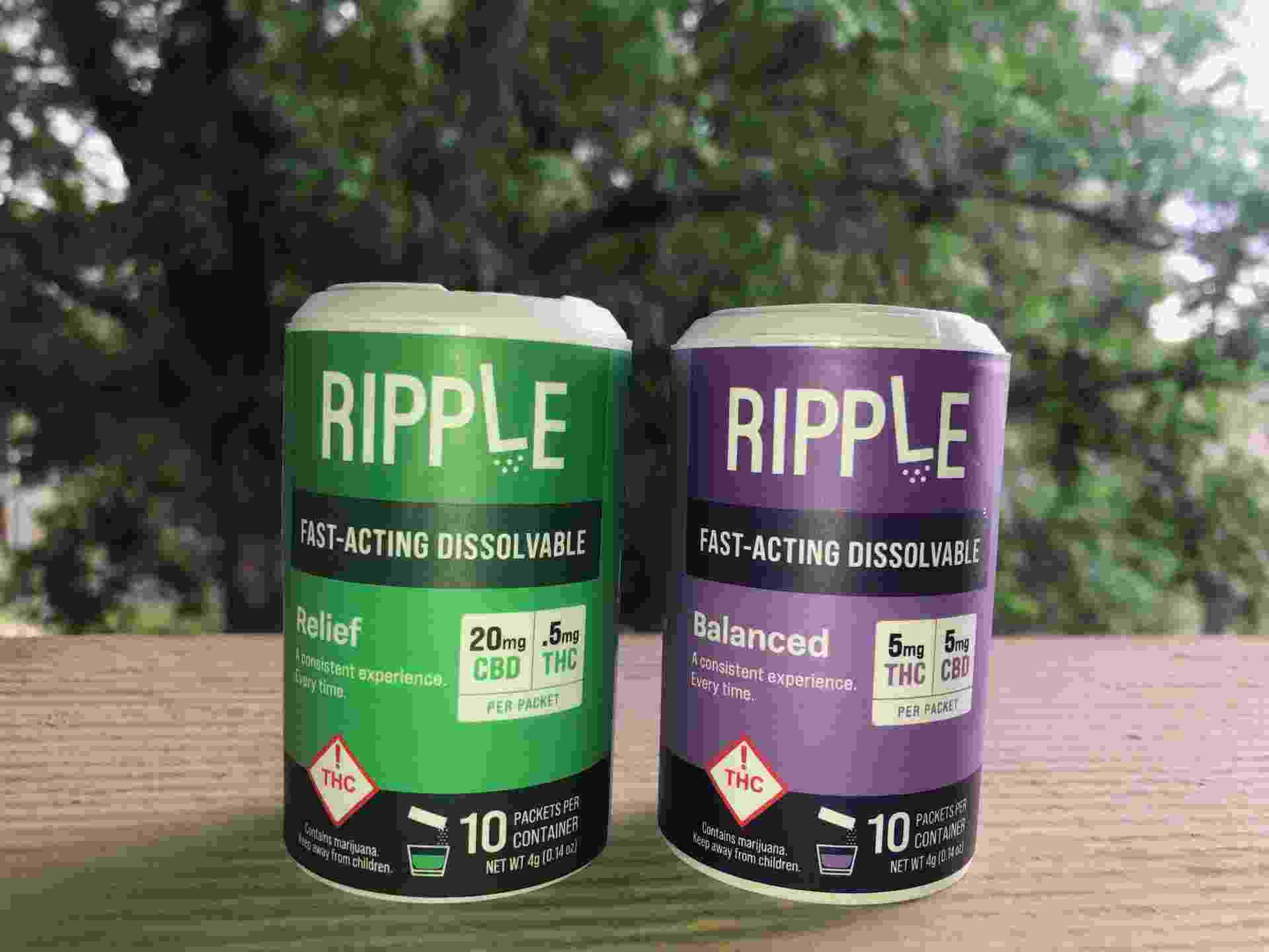 Two plastic containers that have the branded name Ripple on them, one is green and one is purple
