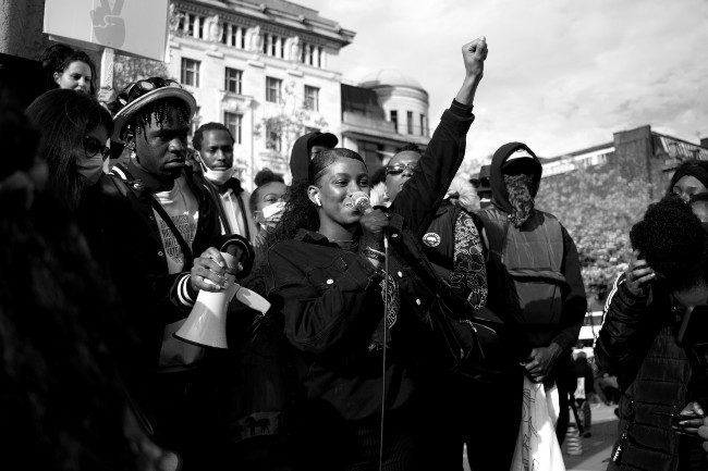 Person's of color speaking at a ralley