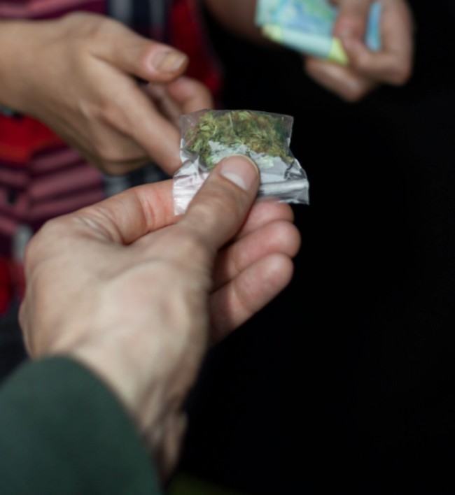 Someone buying weed illegally from the black/gray market