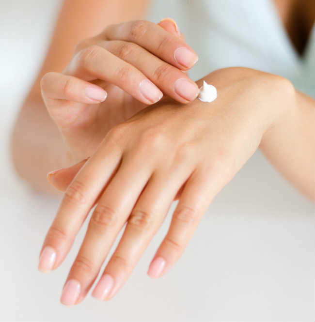 Someone applying a topical to their skin