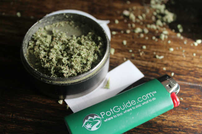 A cannabis grinder with PotGuide light next to it