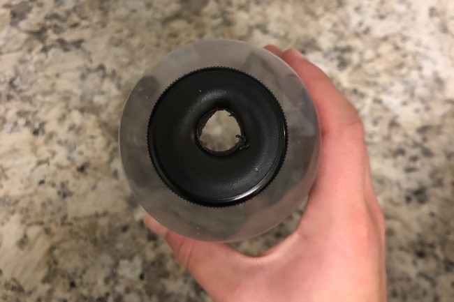 a waterbottle lid with a hole cut in it