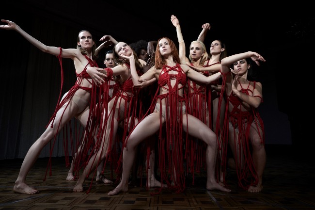 The suspiria movie cover, a bunch of women dressed in red dancing